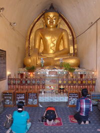 Statue of people in temple outside building