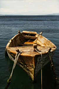 Boat moored in sea against sky