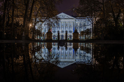 Reflection of building in lake at night