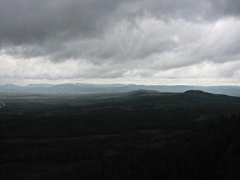 Scenic view of mountains against cloudy sky