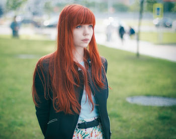 Portrait of beautiful young woman standing outdoors