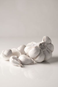 Close-up of garlic on table against white background