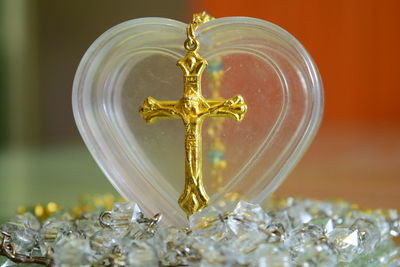 Close-up of rosary bead with heart shape container