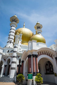 Low angle view of mosque against blue sky