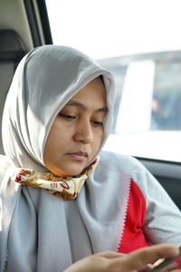 Portrait of mid adult woman sitting in car