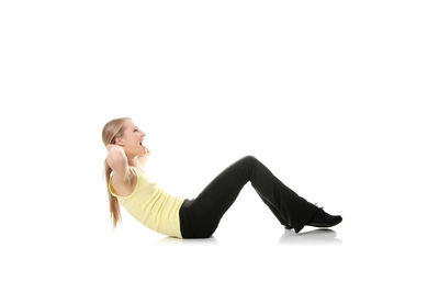 Side view of young woman against white background