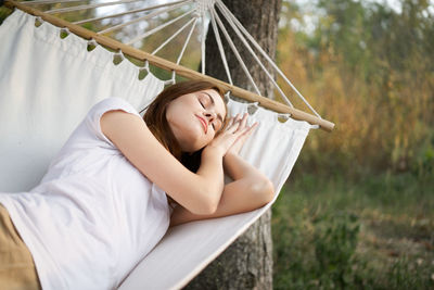 Woman sitting on hammock