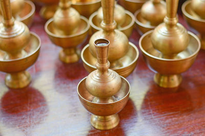 High angle view of antique containers on wooden table