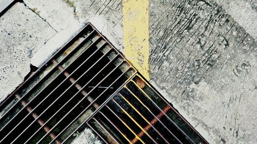 High angle view of metal grate on street