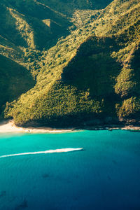 Aerial view of sea by mountain