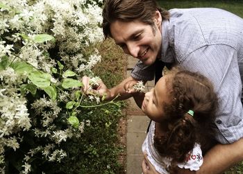 Young woman with dog in mouth