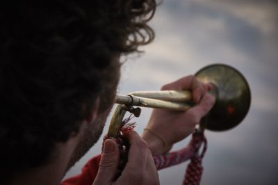 Cropped image of man playing bugle