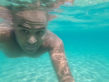 Portrait of young woman swimming in pool