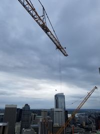 Low angle view of crane against sky