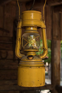 Close-up of old lantern hanging outside house