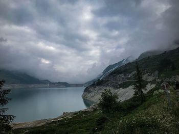 Scenic view of sea and mountains against sky