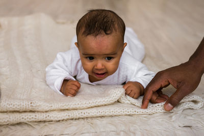 Portrait of cute baby on bed