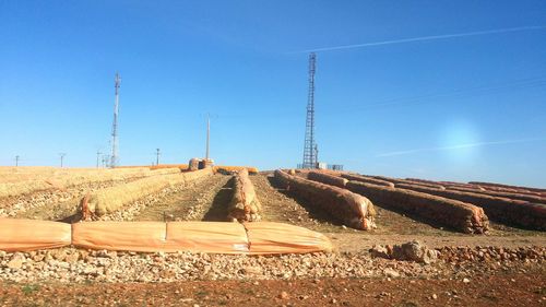 View of construction site against clear blue sky