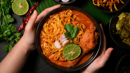 Cropped hand of woman holding food