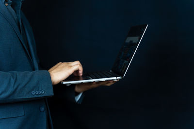 Midsection of man using laptop