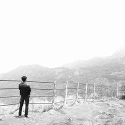 Rear view of woman standing on mountain