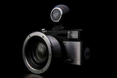 Close-up of camera over black background