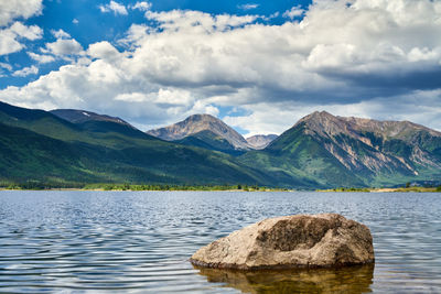 Scenic view of lake and mountains against sky