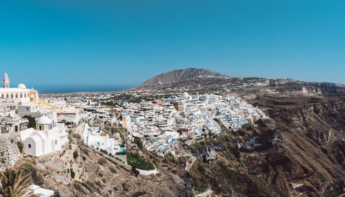 Cityscape against clear blue sky