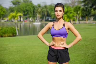 Portrait of young woman exercising in park