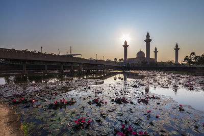 View of bridge over water at sunset