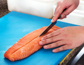 Close-up of man preparing food on cutting board