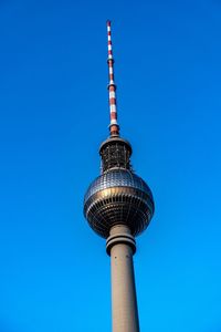 Low angle view of fernsehturm against clear blue sky