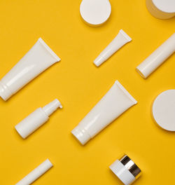 High angle view of beauty products on yellow background