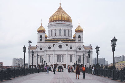 Group of people in front of building against sky