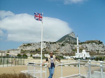 Man standing at beach against sky