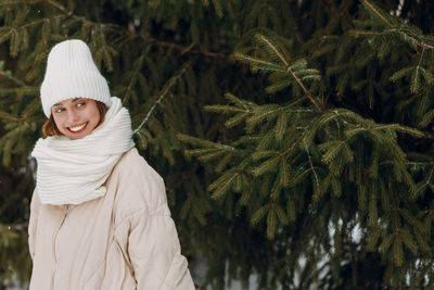 Portrait of woman standing against plants