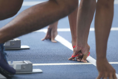 Close-up of athletes on running track