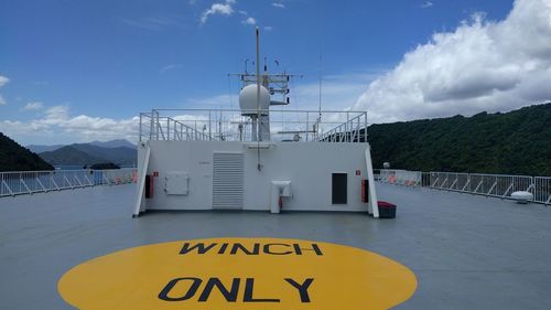 Information sign on ship against sky