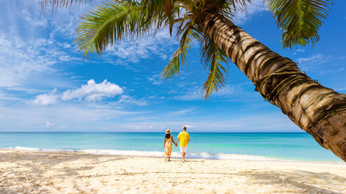 People on beach against sky