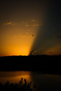 Scenic view of lake against romantic sky at sunset
