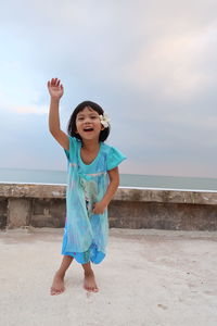 Full length of girl standing on beach