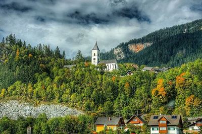 Buildings against cloudy sky