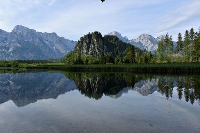 Scenic view of lake and mountains against sky