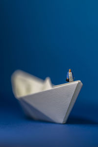 Close up of a origami paper ship with miniature figure on it