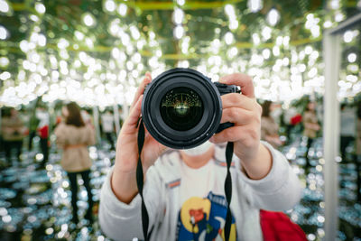 Person with camera in mirror maze