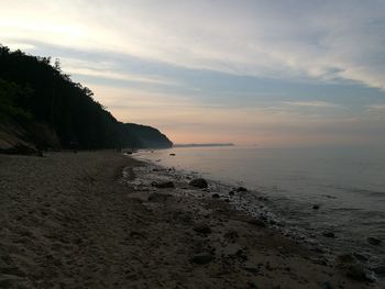 Scenic view of beach against sky during sunset