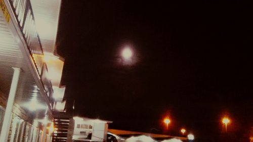 Low angle view of illuminated street light at night