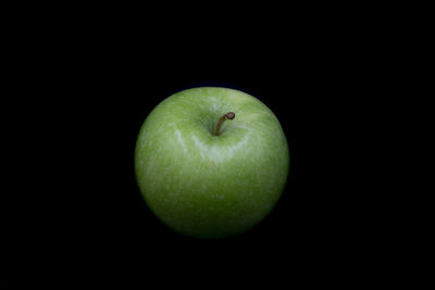 Close-up of apple against black background