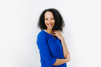 Portrait of a smiling young woman against white background