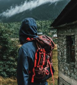 Rear view of woman standing against mountain